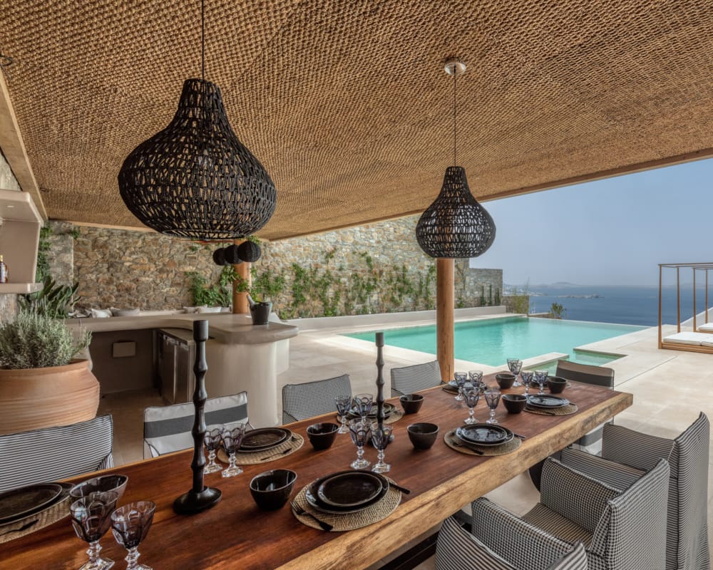 a table with a lamp and a table with plates and glasses on it