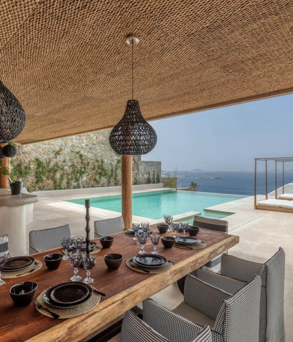 a table with a lamp and a table with plates and glasses on it