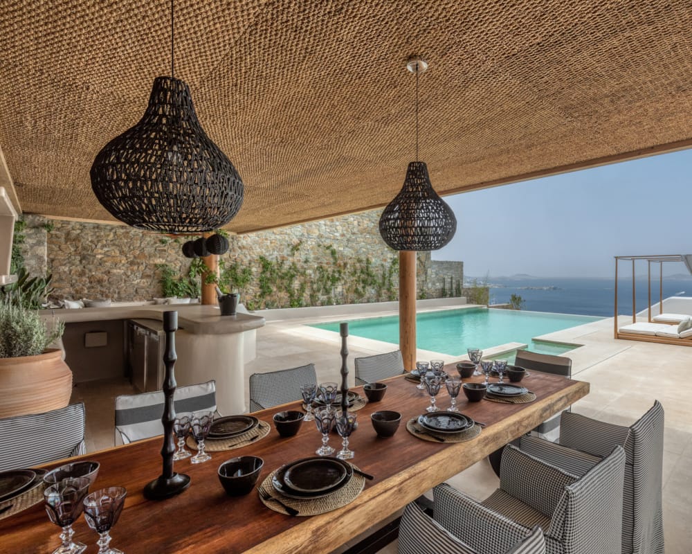 a table with a lamp and a table with plates and glasses on it