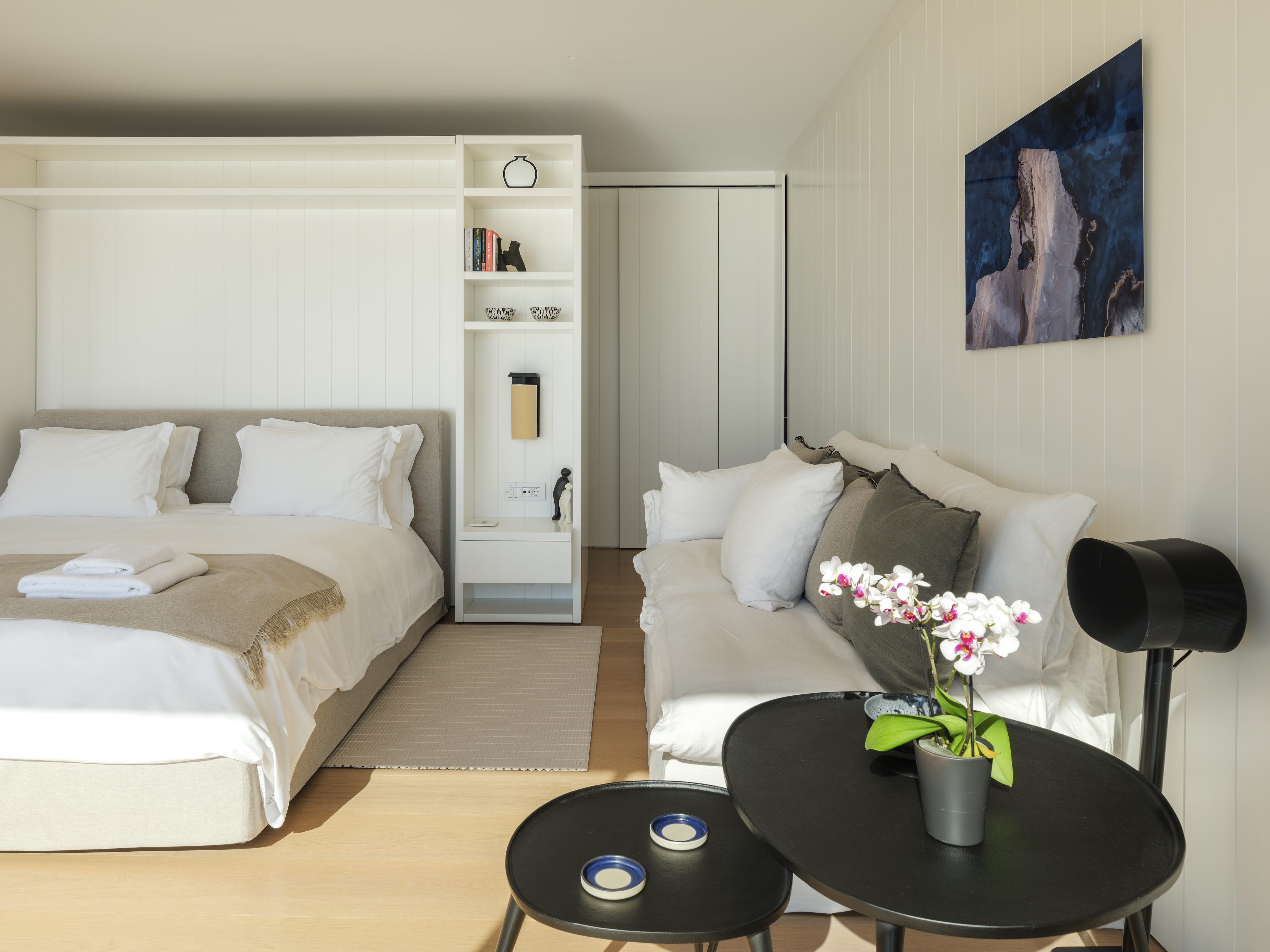 a room with a couch and a table with a lamp