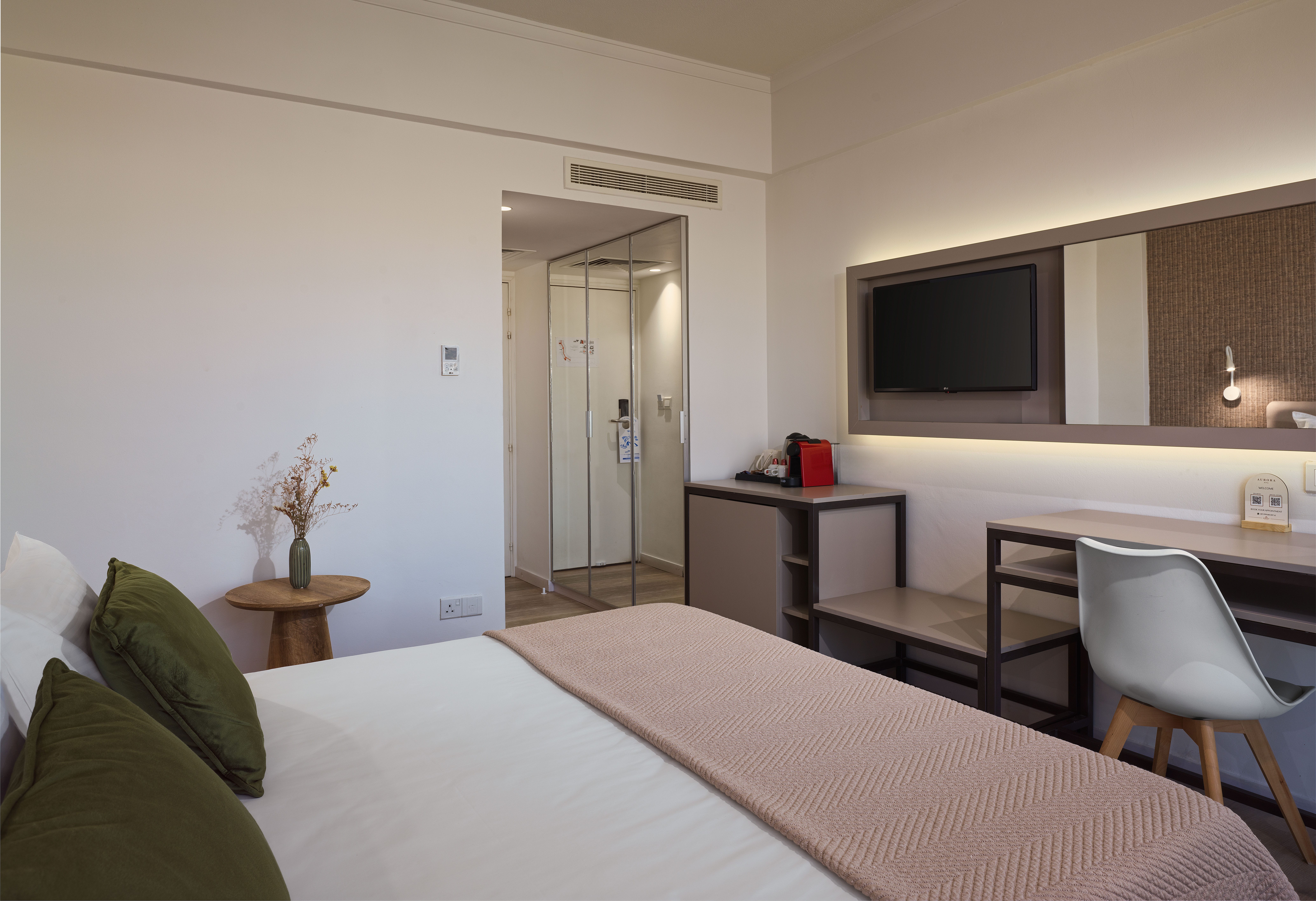 a bedroom with a bed and a mirror
