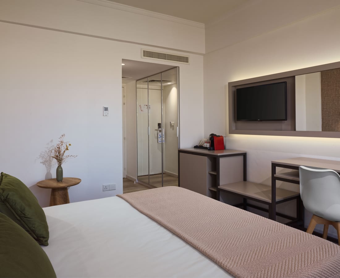 a bedroom with a bed and a mirror