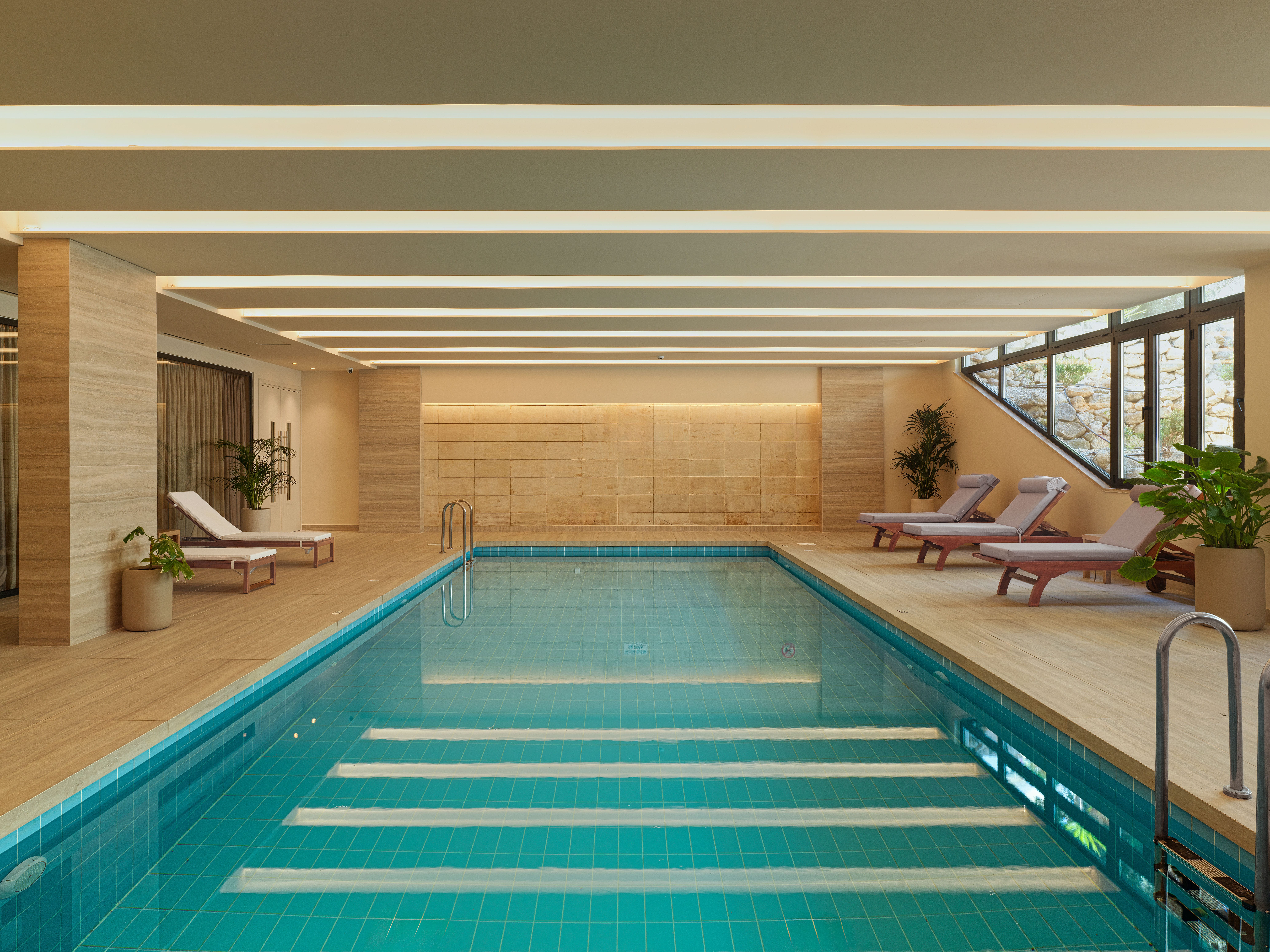 a swimming pool with lounge chairs