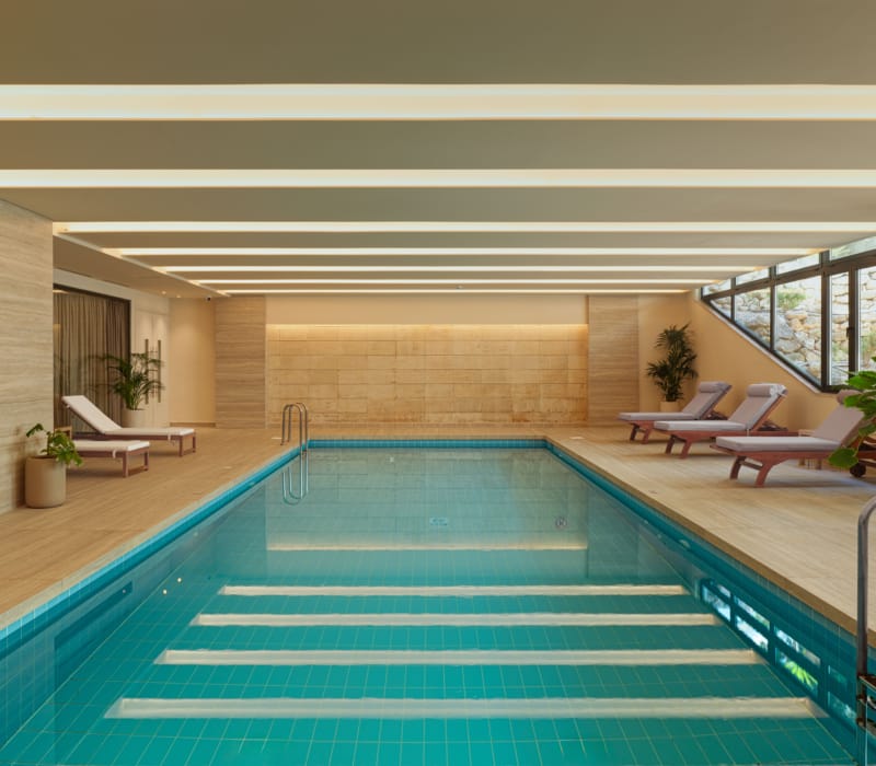 a swimming pool with lounge chairs