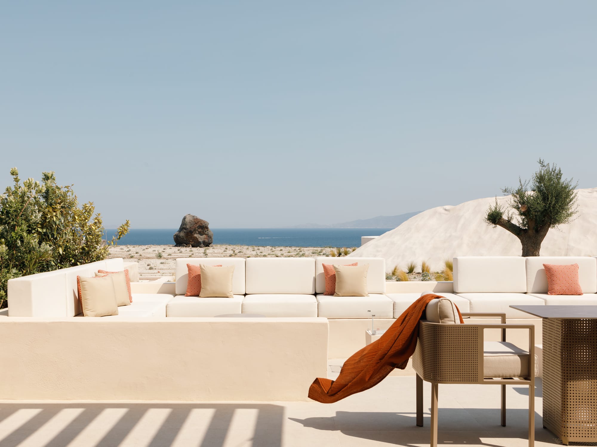 a couch and a table with a view of the ocean
