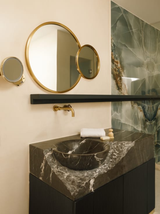 a bathroom with a mirror and a sink