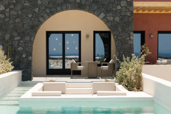 a pool with a large stone arch