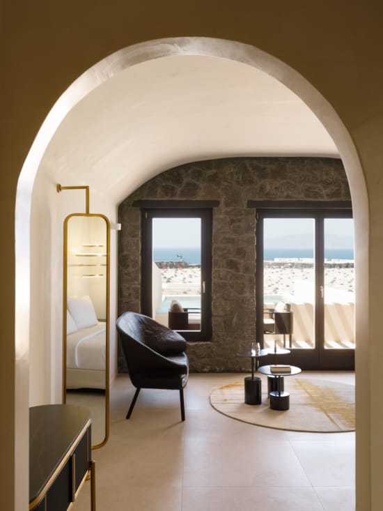 a room with a fireplace and chairs