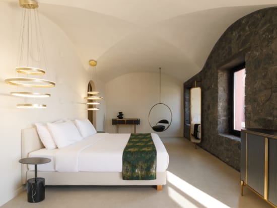 a large bedroom with a bed and a mirror