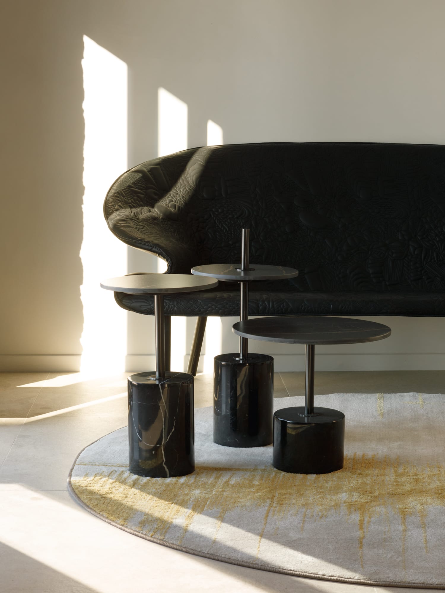 a black couch and stools