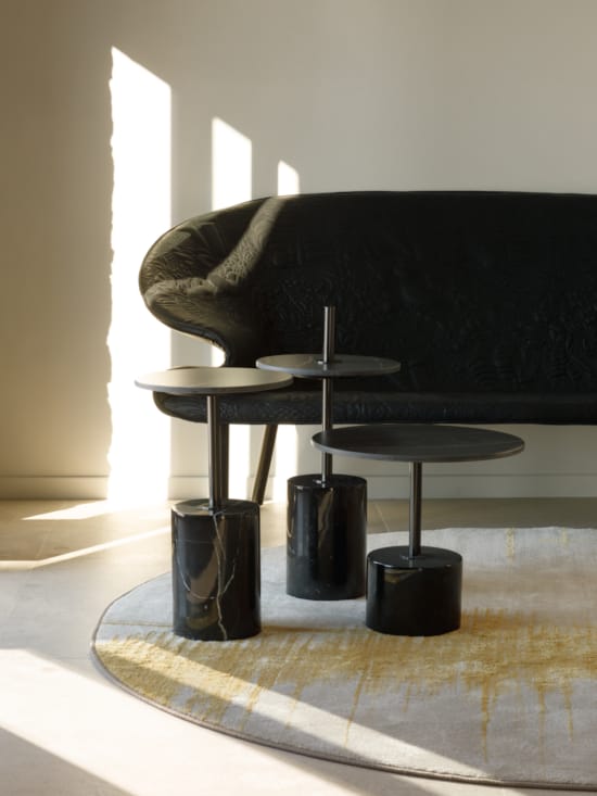 a black couch and stools