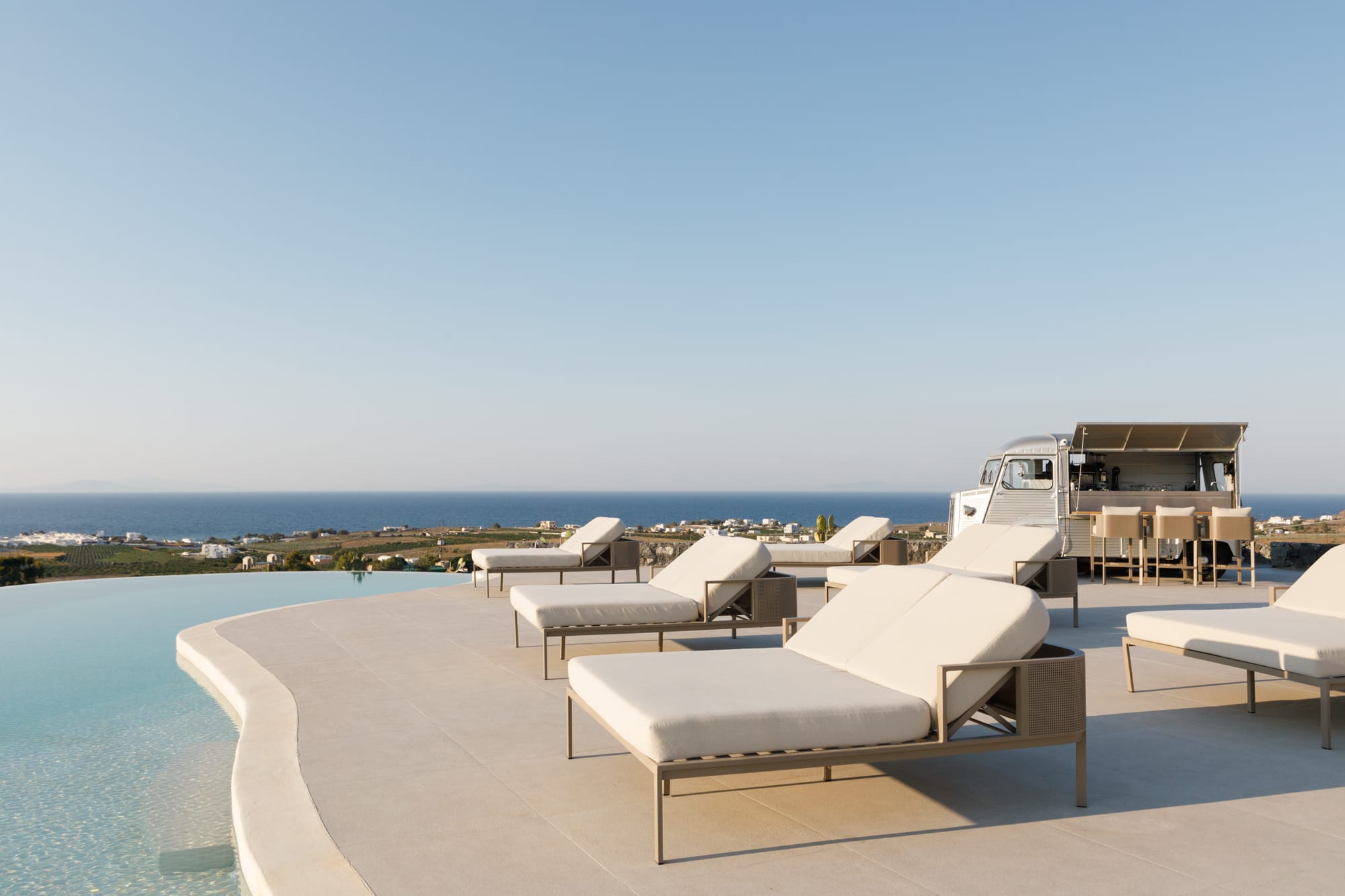 a row of lounge chairs on a beach