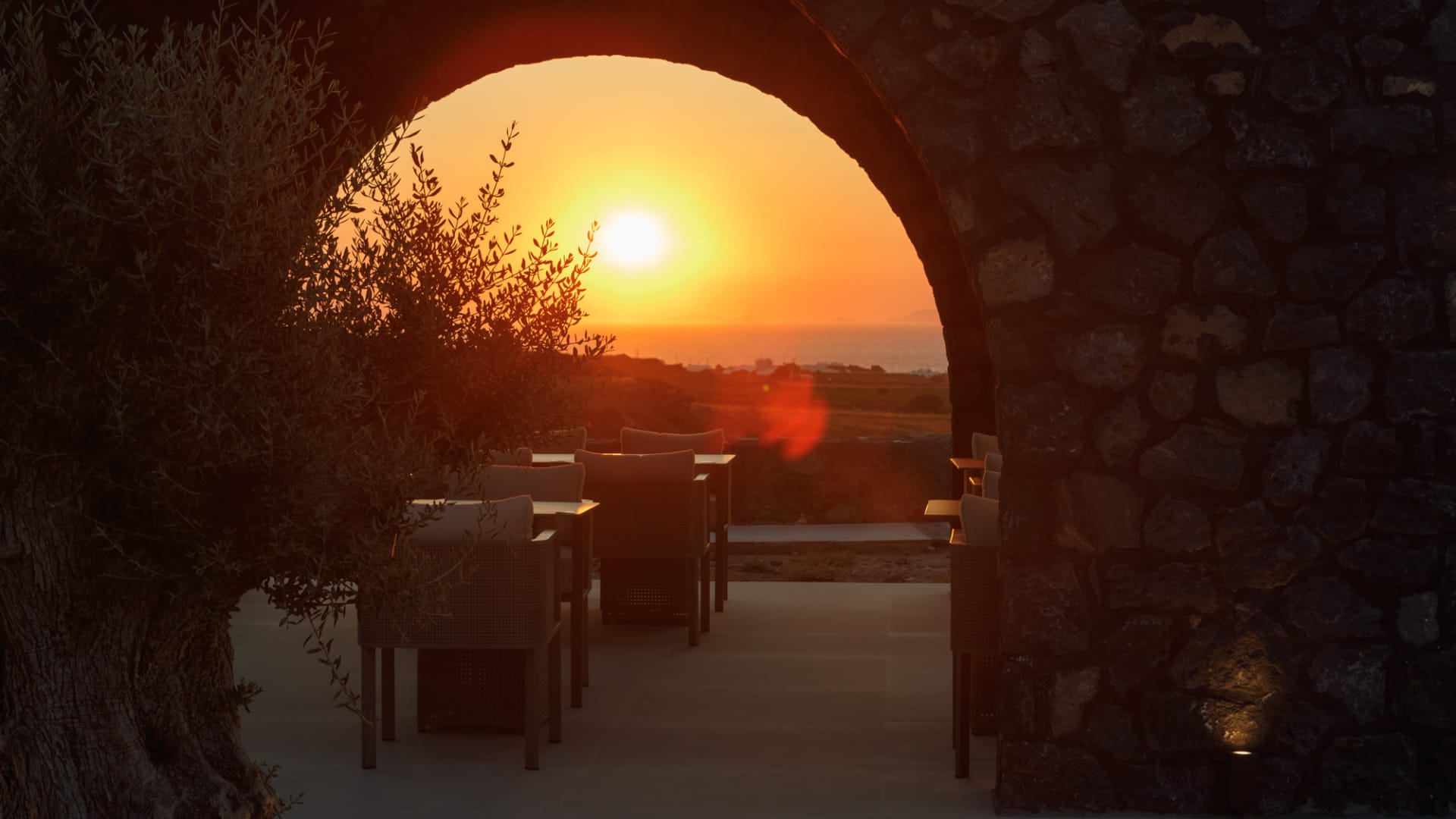 a stone archway with a sunset