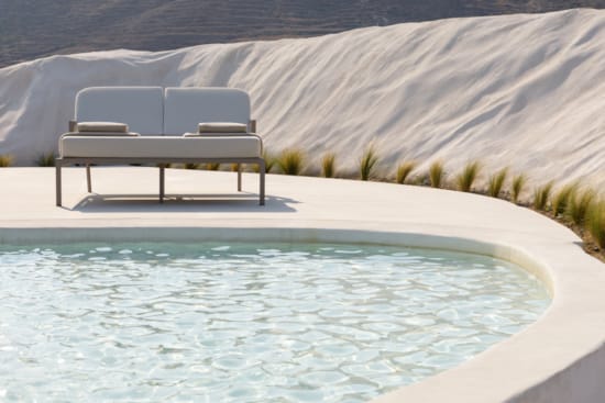 a bench sits in the middle of a pool