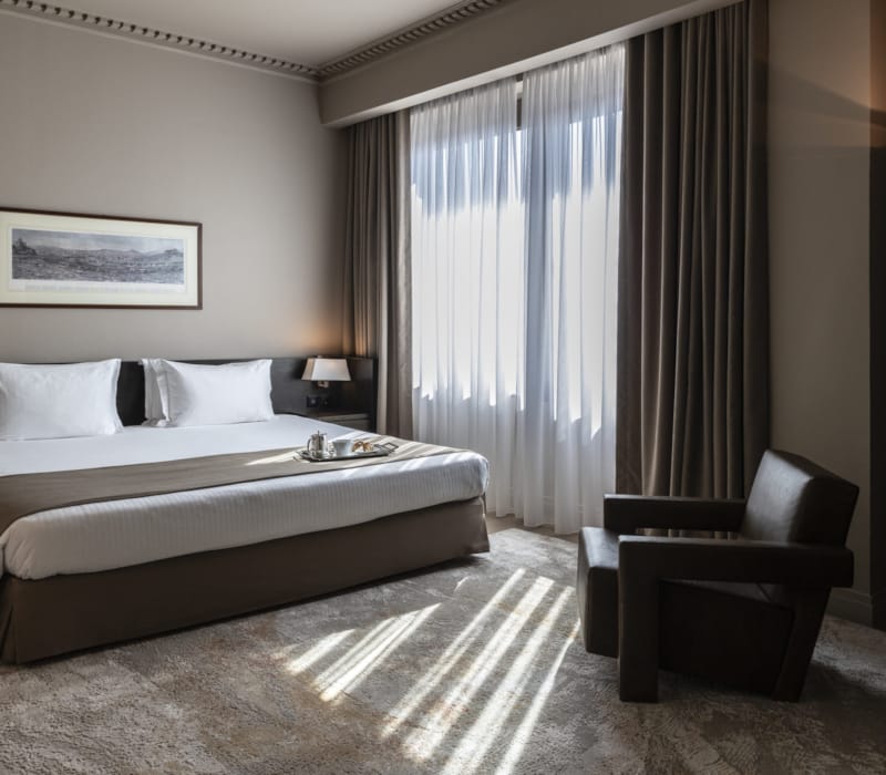 a bedroom with a bed and a chair