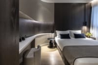 a bedroom with a bed and a bathtub