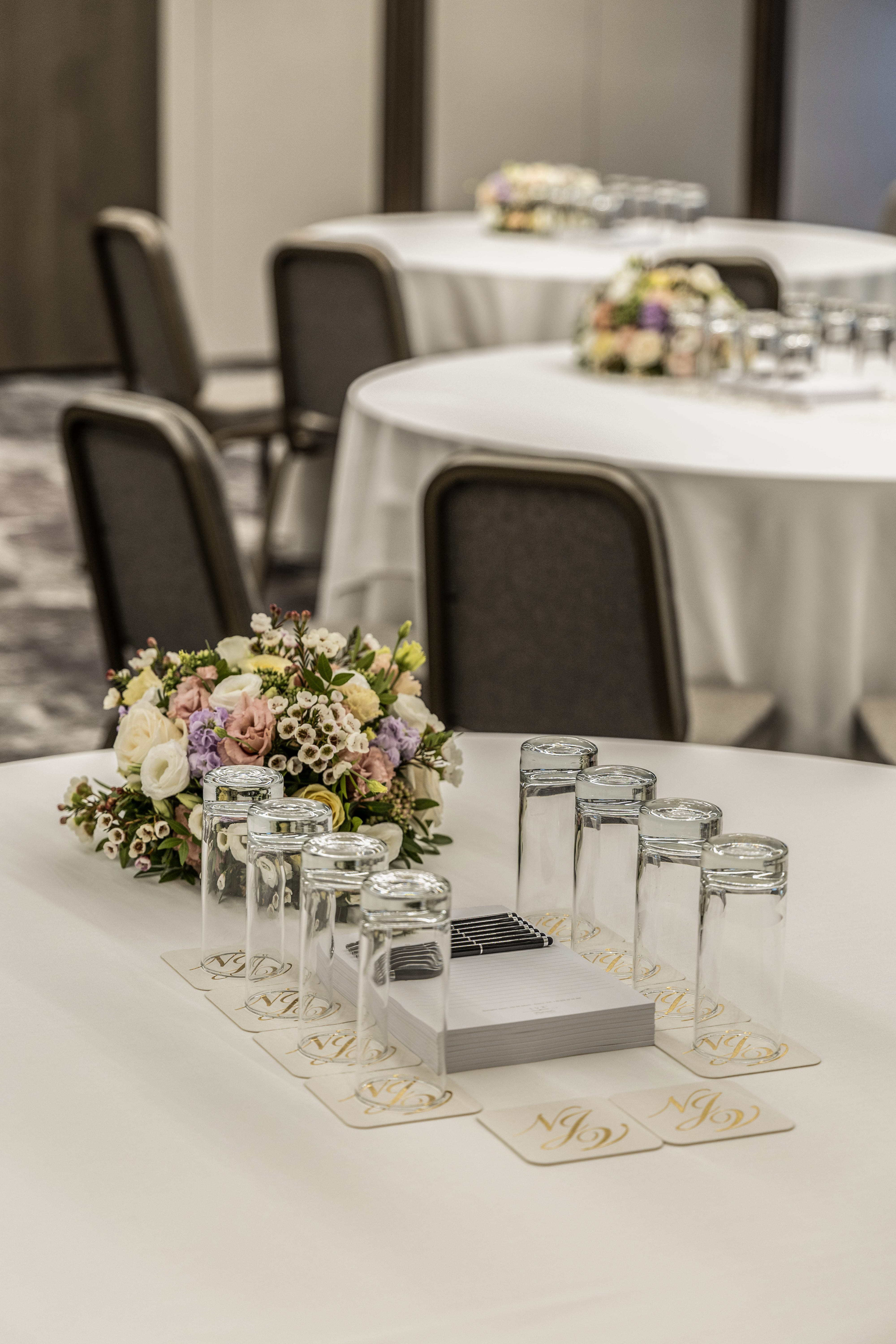 a table with glasses and flowers