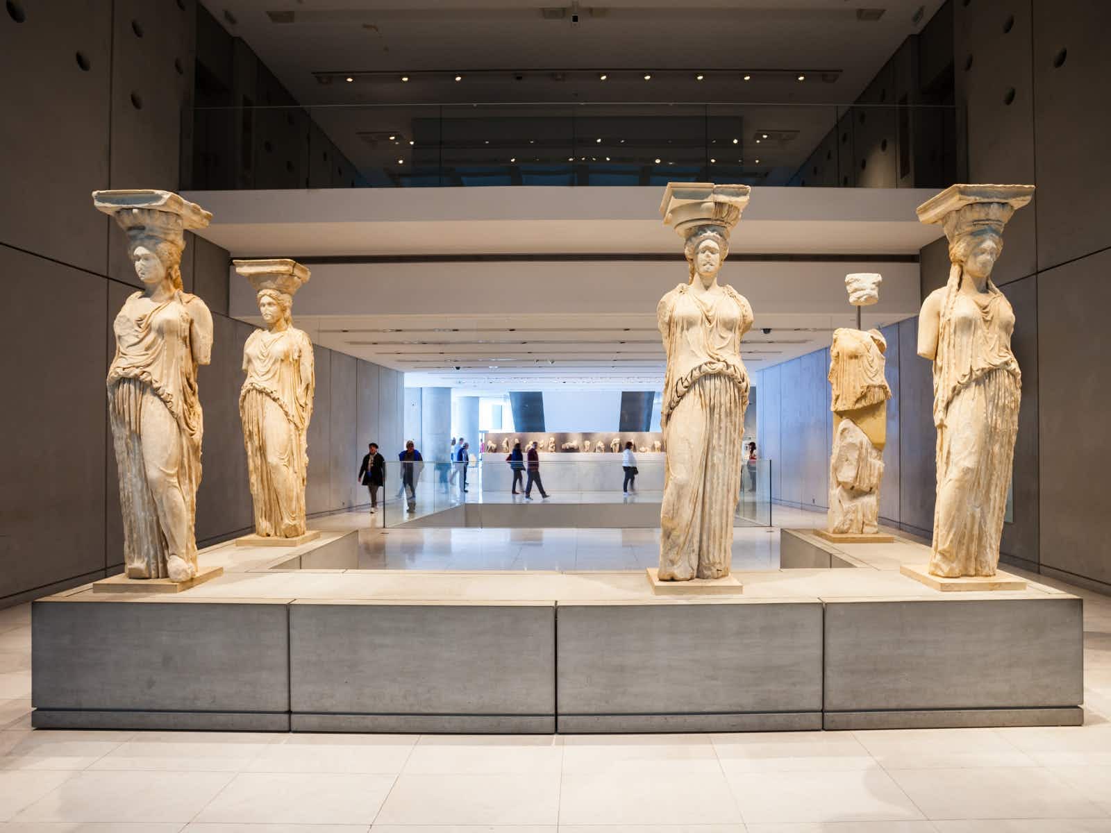 a group of statues in a museum