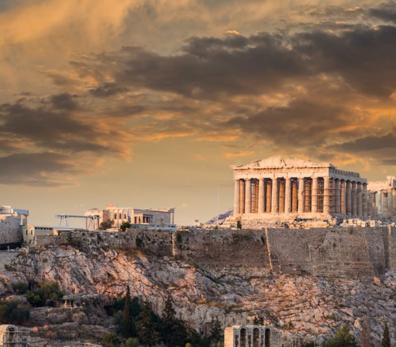 a large building with columns on a hill