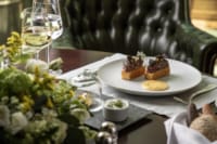 a plate of desserts and a glass of wine on a table