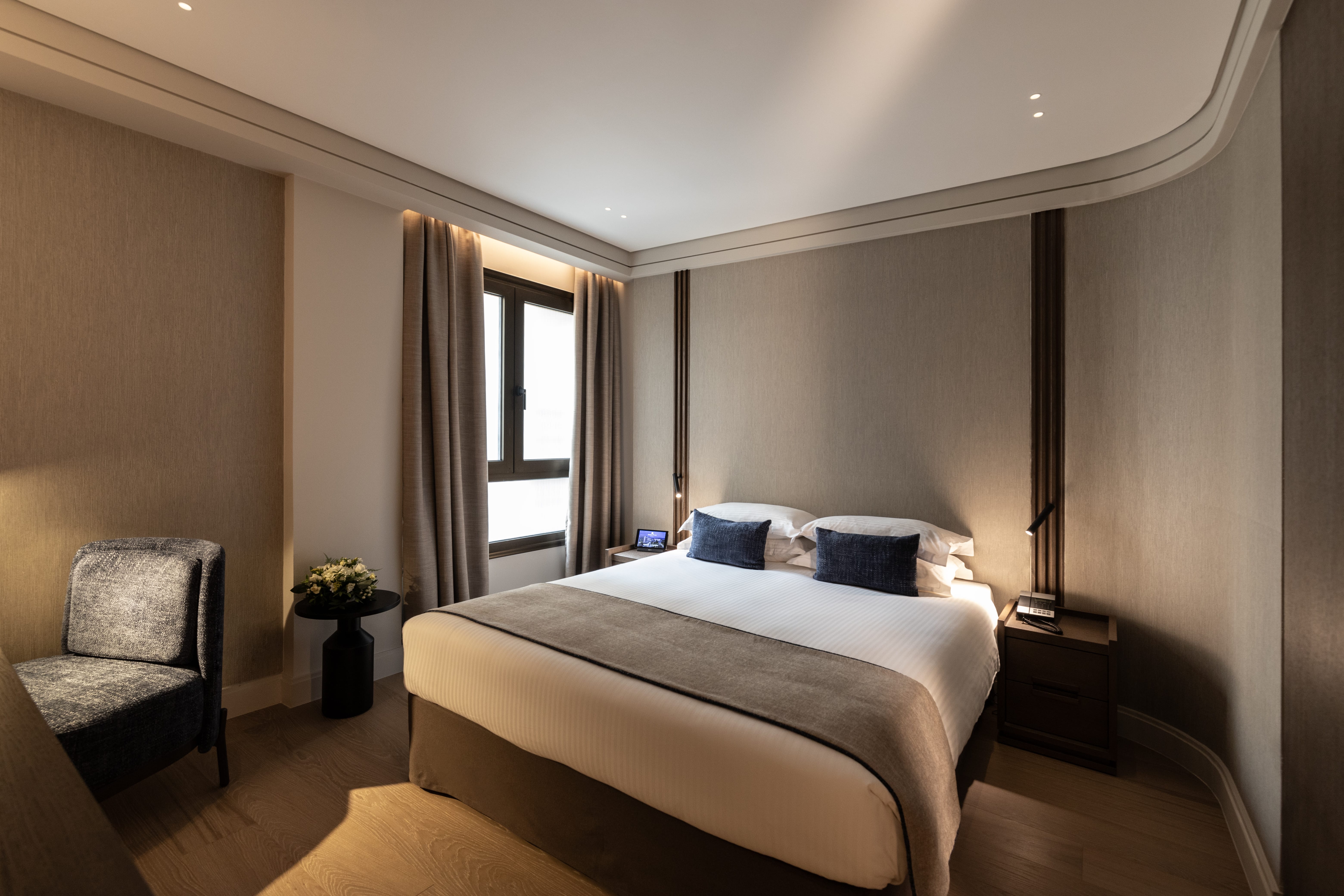 a bedroom with a bed and a chair