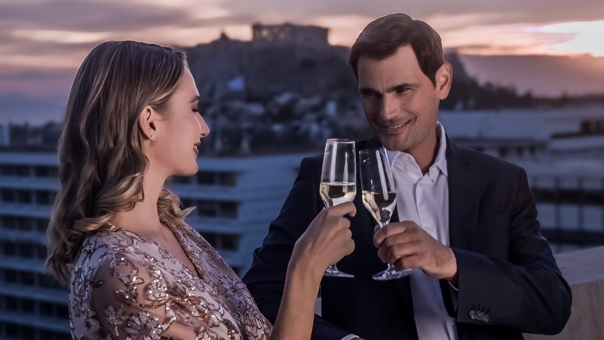 a man and woman holding glasses