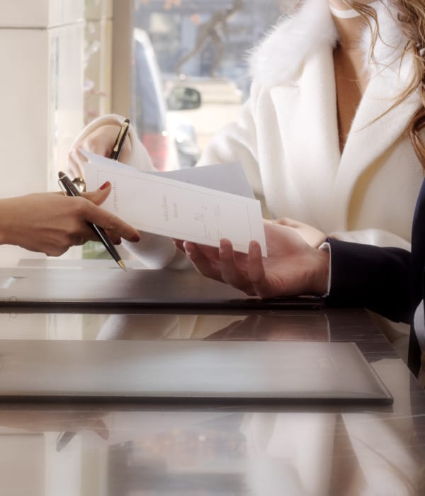 a woman writing on a piece of paper