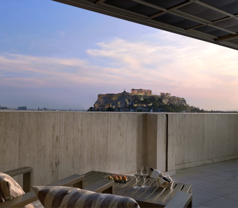 a wall with a view of a city and a hill in the distance