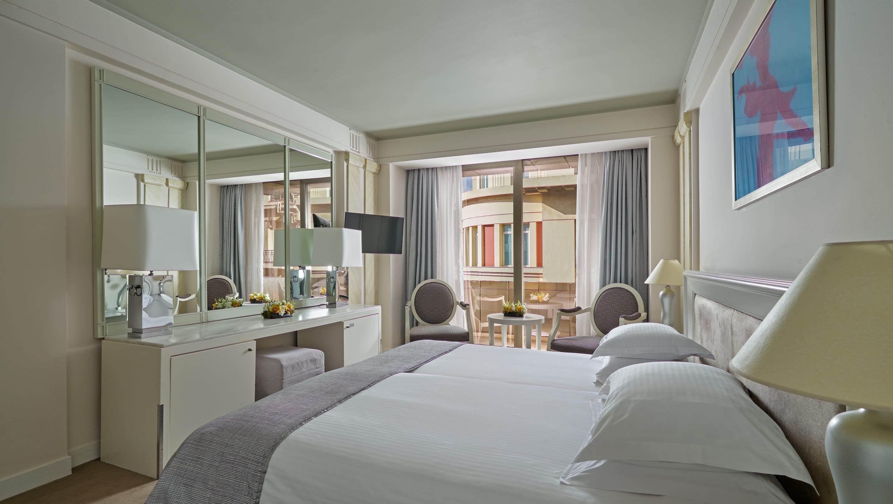 a hotel room with a bed and a desk