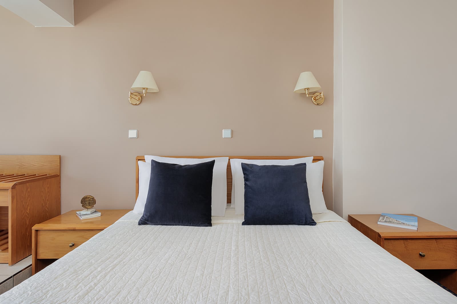 a bed with a white and blue comforter