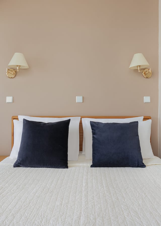 a bed with a white and blue comforter