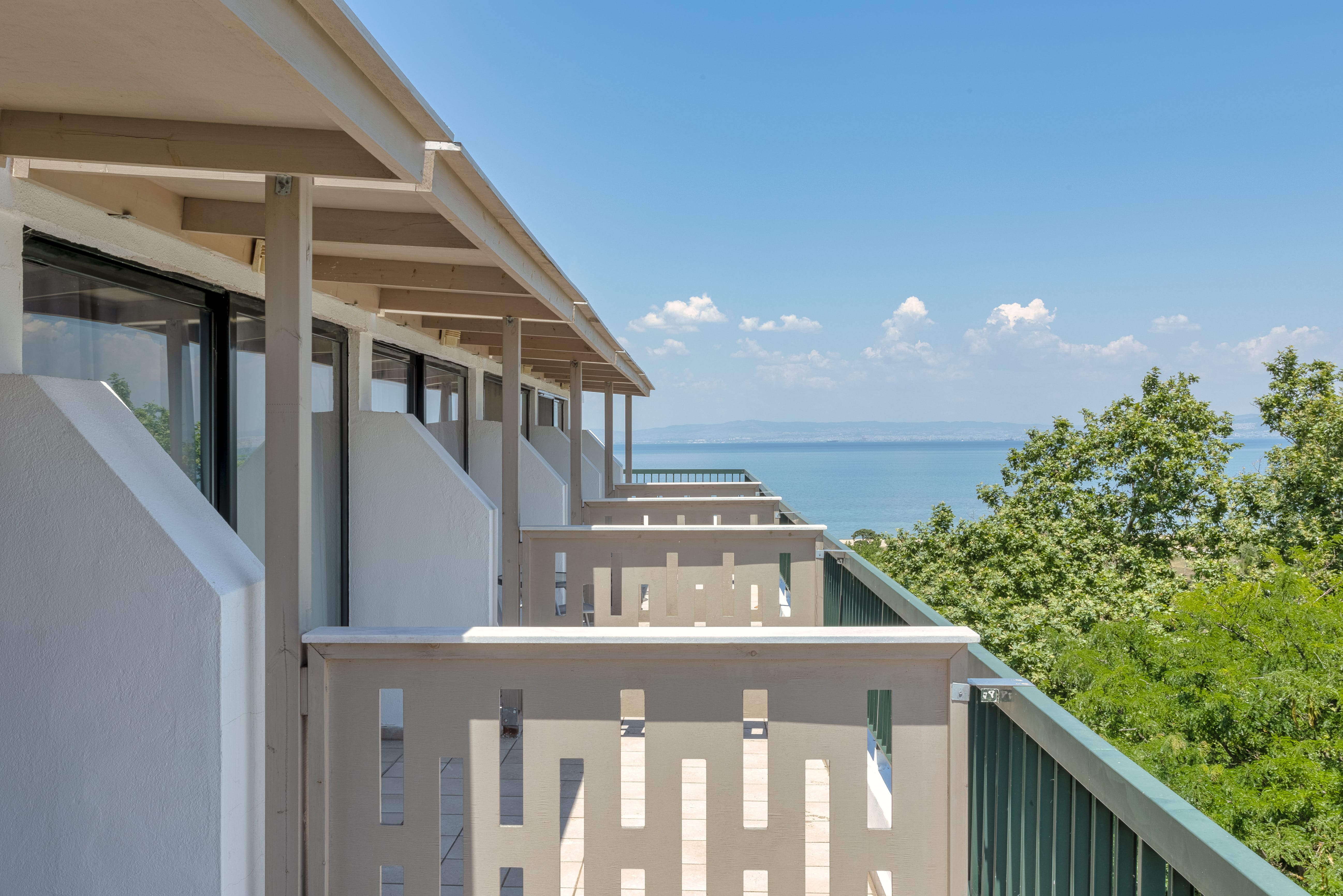 a building with a body of water in the background