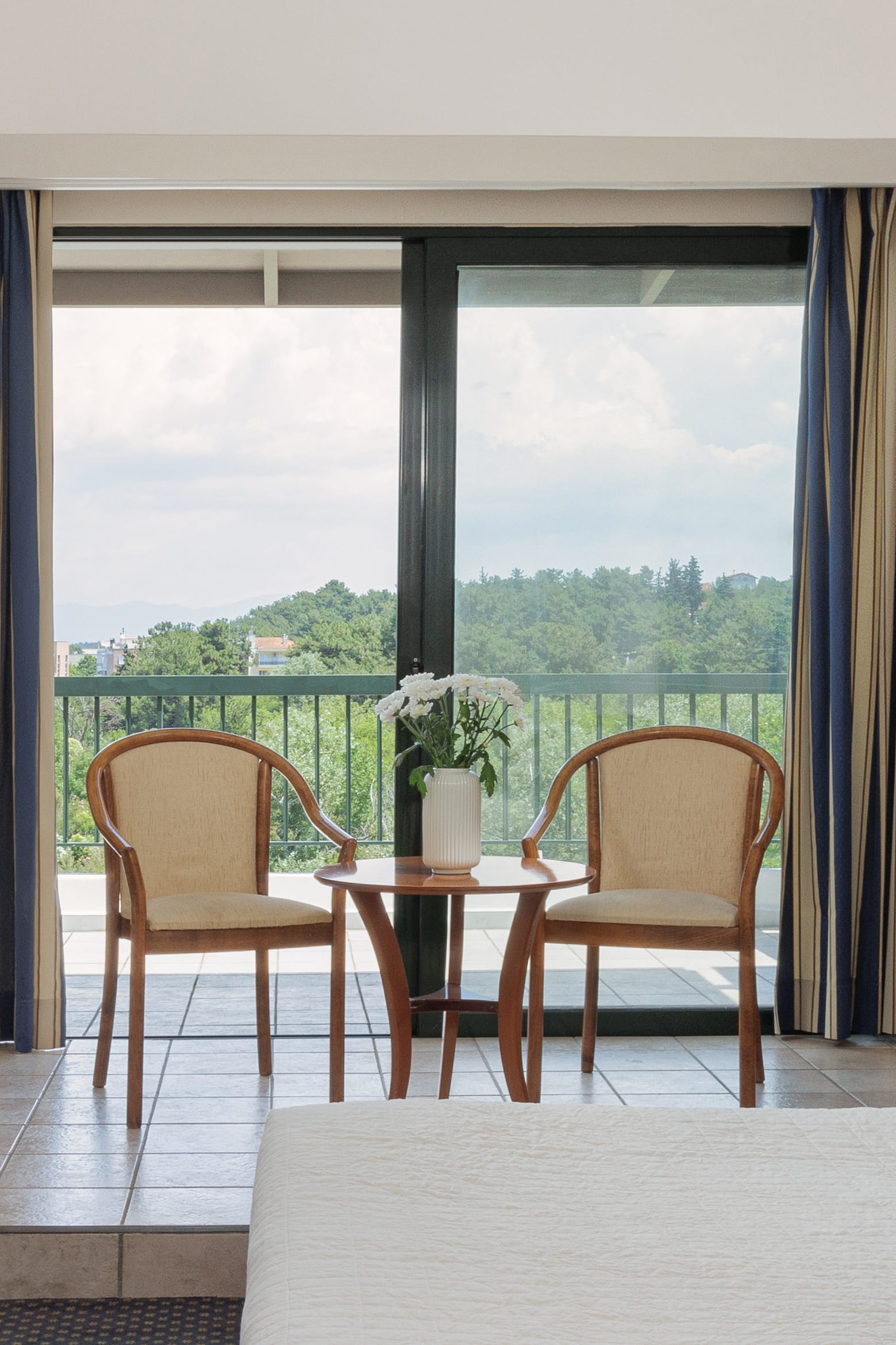 a table and chairs in front of a window with a view of a city