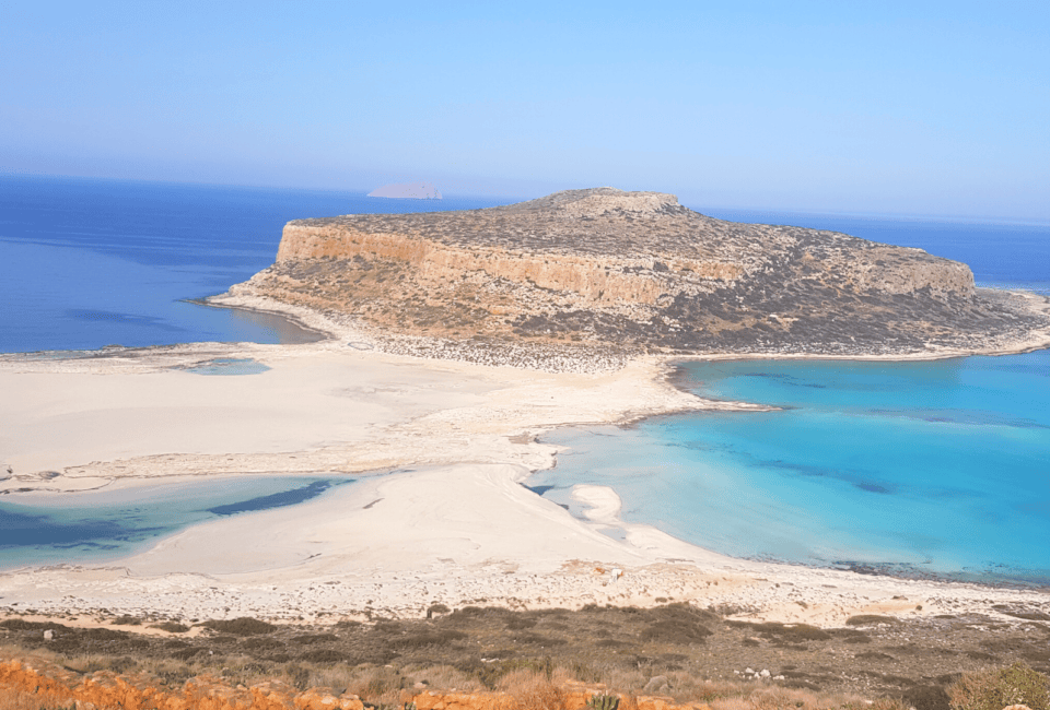 a sandy beach with a small island