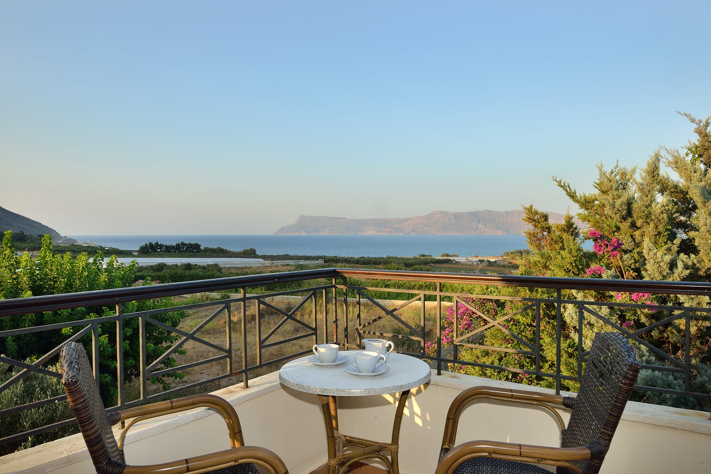 a table and chairs on a balcony