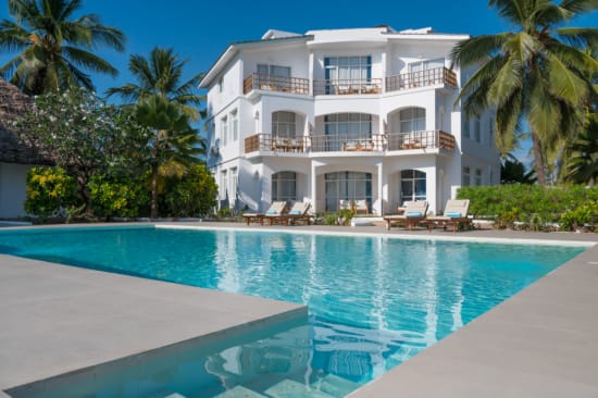 a large white house with a pool