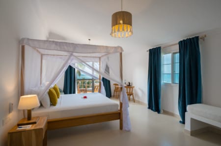 a bedroom with a bed and a lamp