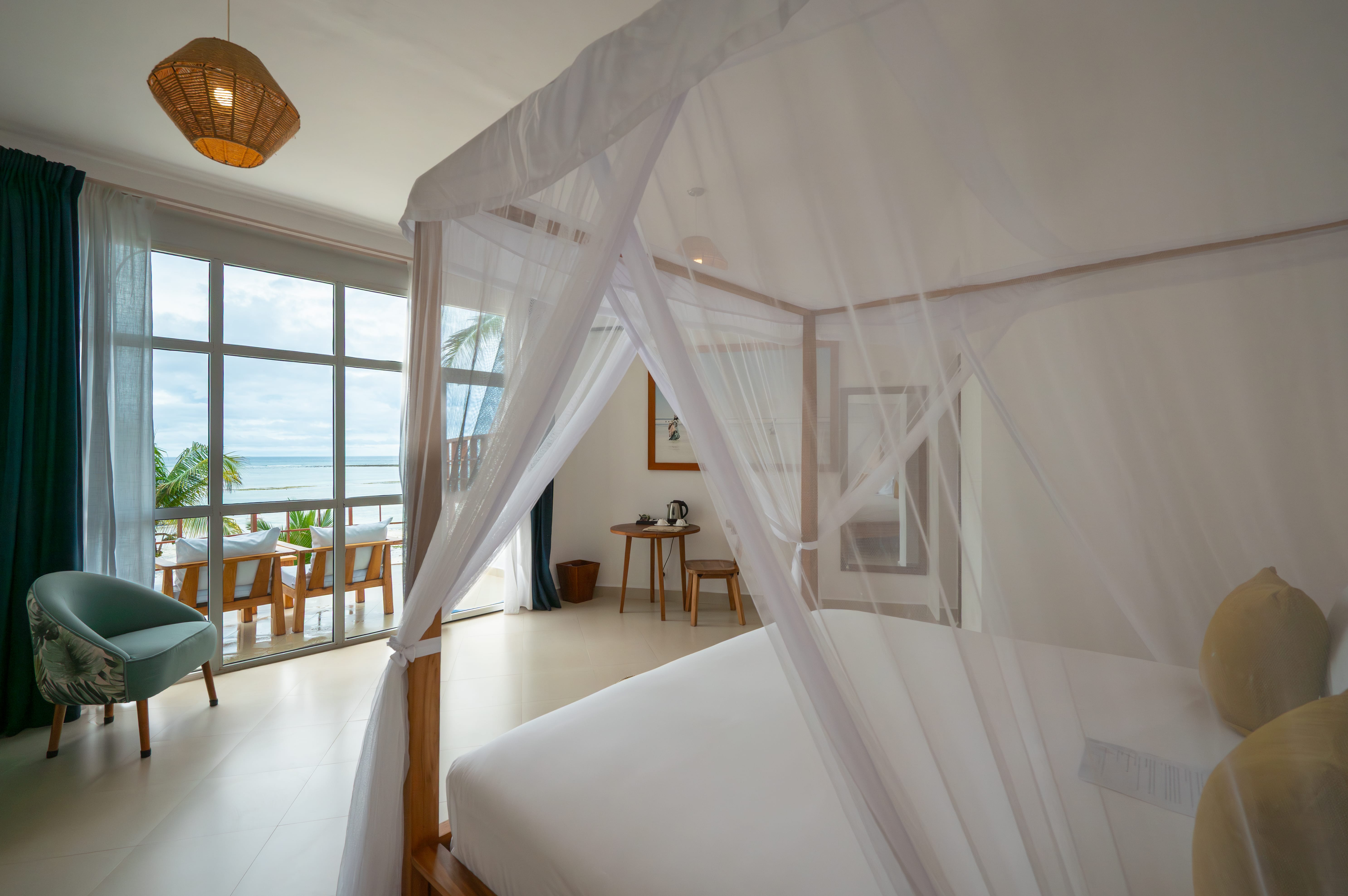 a bedroom with a bed and chairs