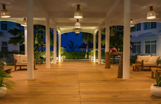 a room with a wood floor and white pillars and a wood floor
