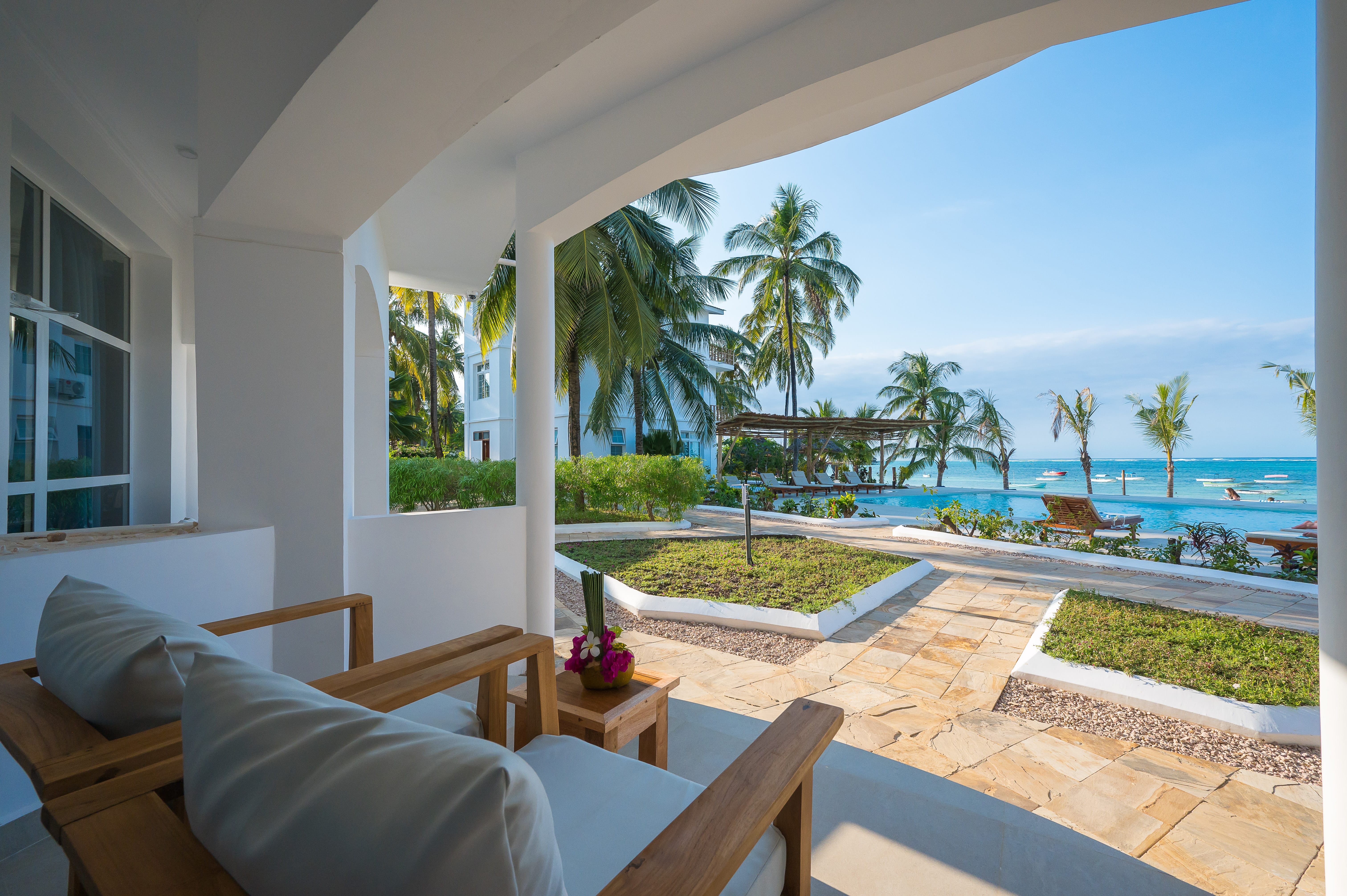 a room with a pool and palm trees
