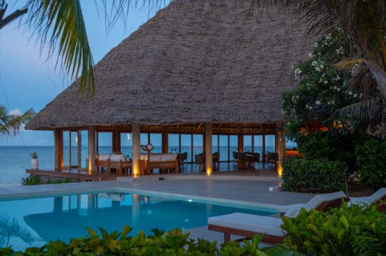 a pool with a house in the background