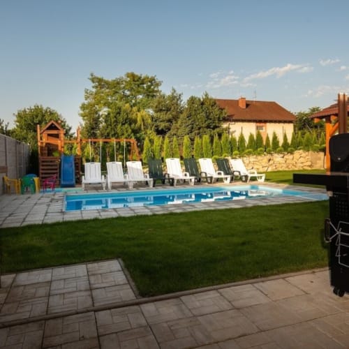 a pool with a grill and a grill by a building