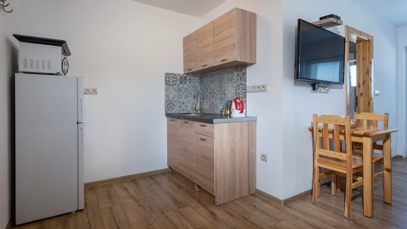 a kitchen with a table and chairs