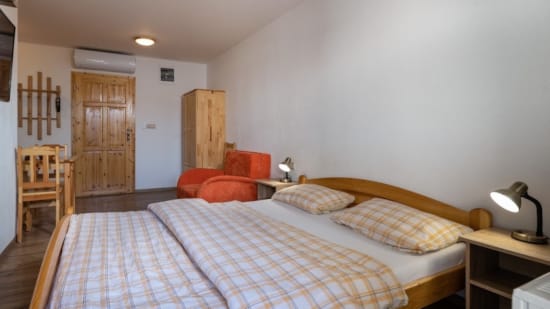 a bedroom with a bed and a chair