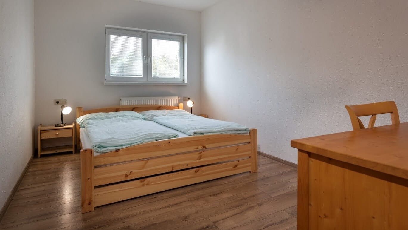 a bedroom with a bed and a dresser