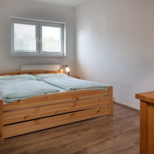 a bedroom with a bed and a dresser