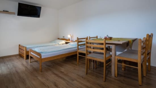 a room with a bed and chairs