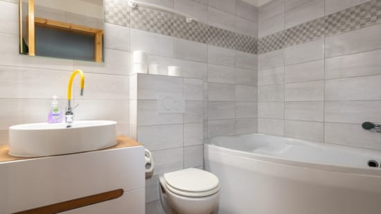 a bathroom with a tub sink and toilet