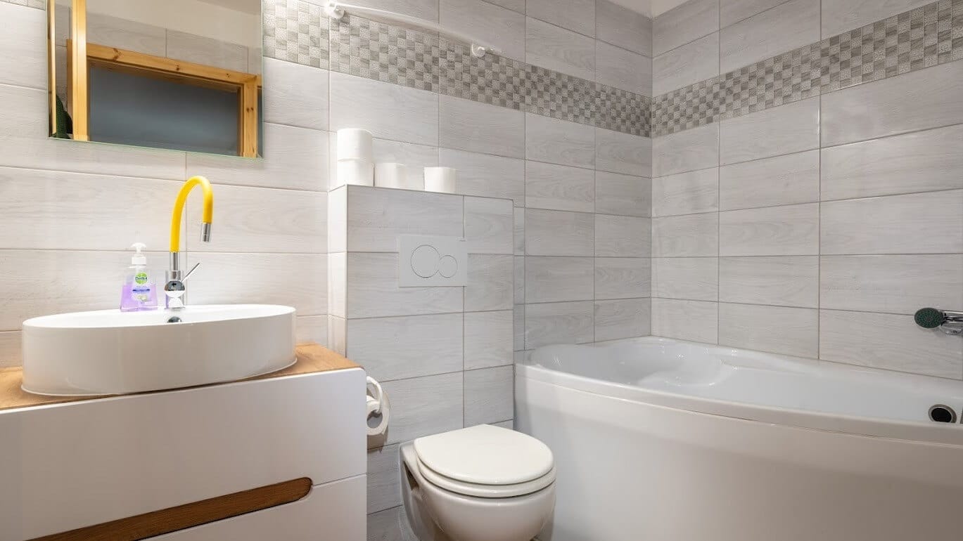 a bathroom with a tub sink and toilet