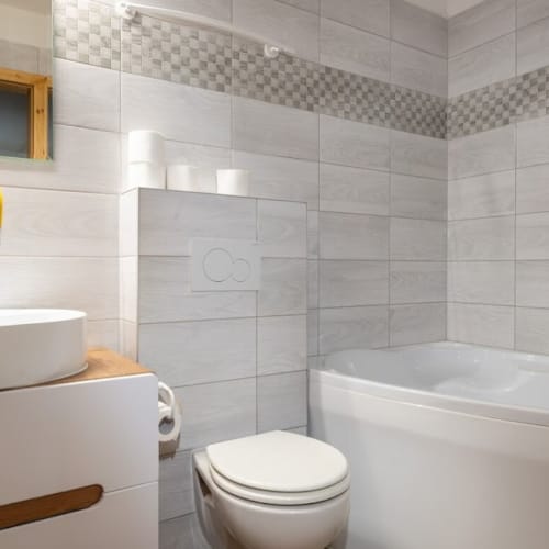 a bathroom with a tub sink and toilet